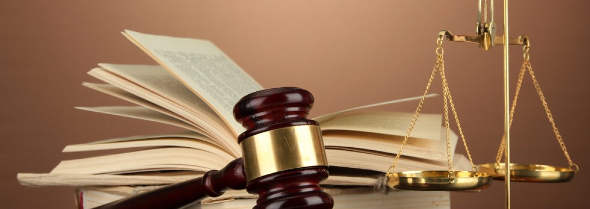 Golden,Scales,Of,Justice,,Gavel,And,Books,On,Brown,Background