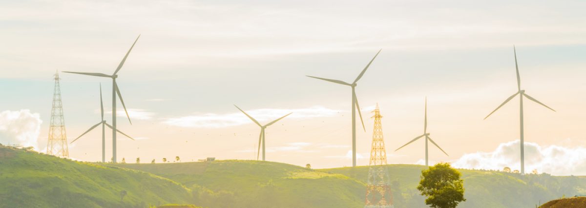 Wind,Turbines,Produce,Electricity,With,Sunlight,During,Sunset,Background.